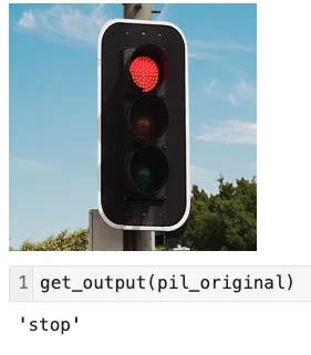 Screenshot from a Jupyter Notebook showing the benign stoplight and the model output: “stop.”