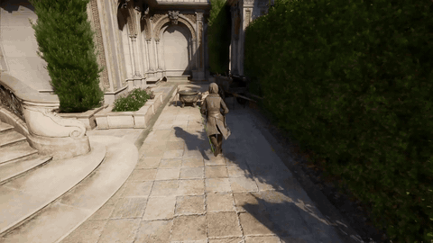 A clothed human character moves through a stone courtyard in an Unreal Engine demonstration of MotionBricks.
