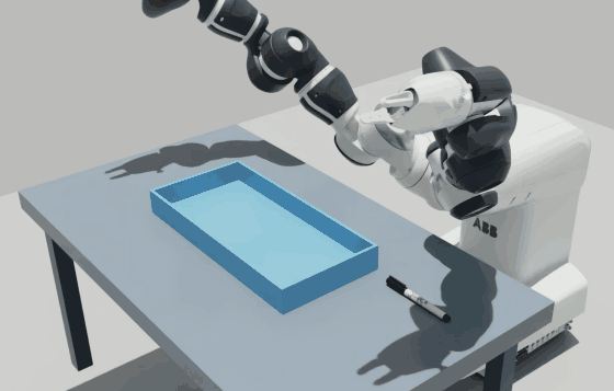 YuMi’s gripper lifts a black-capped marker from a tabletop and releases it into a blue tray.
